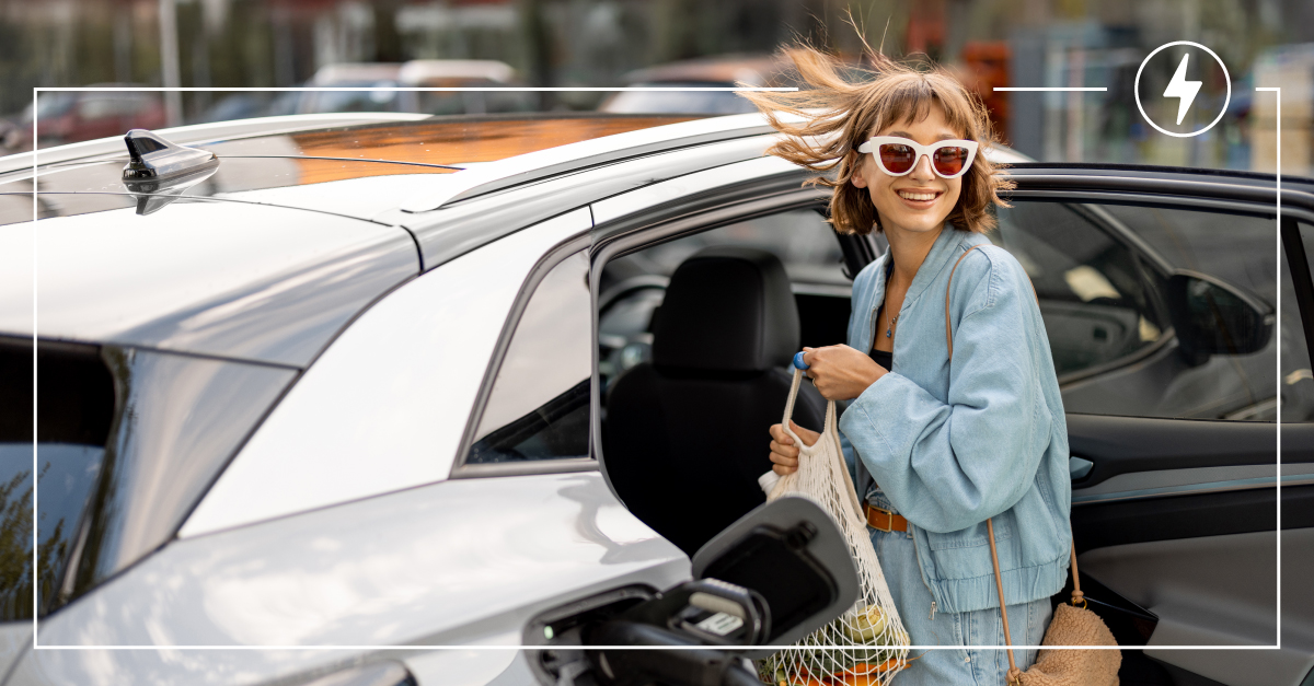 Woman charging electric vehicle